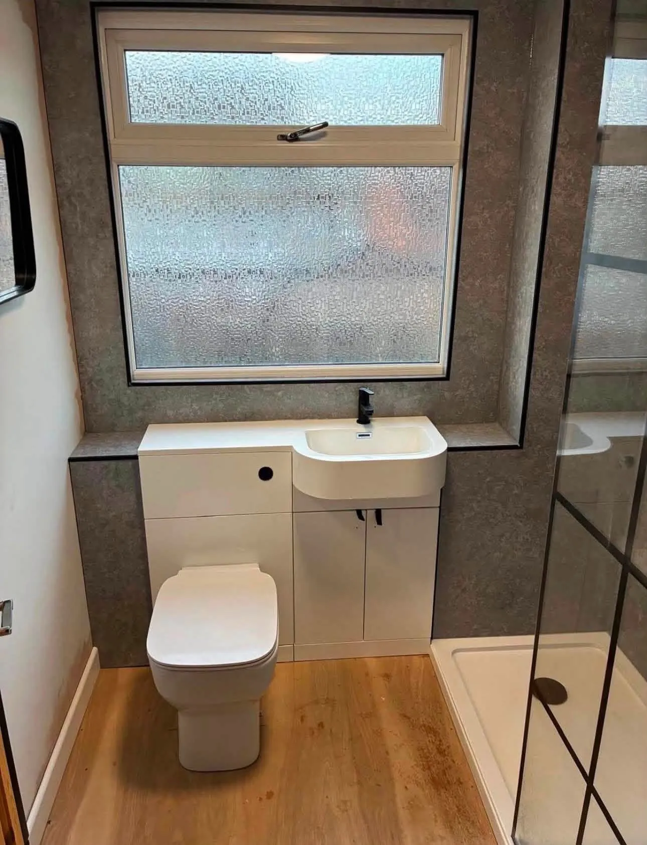 Bathroom toilet and basin vanity unit installed beside a shower tray by Mase Plumbing 24/7