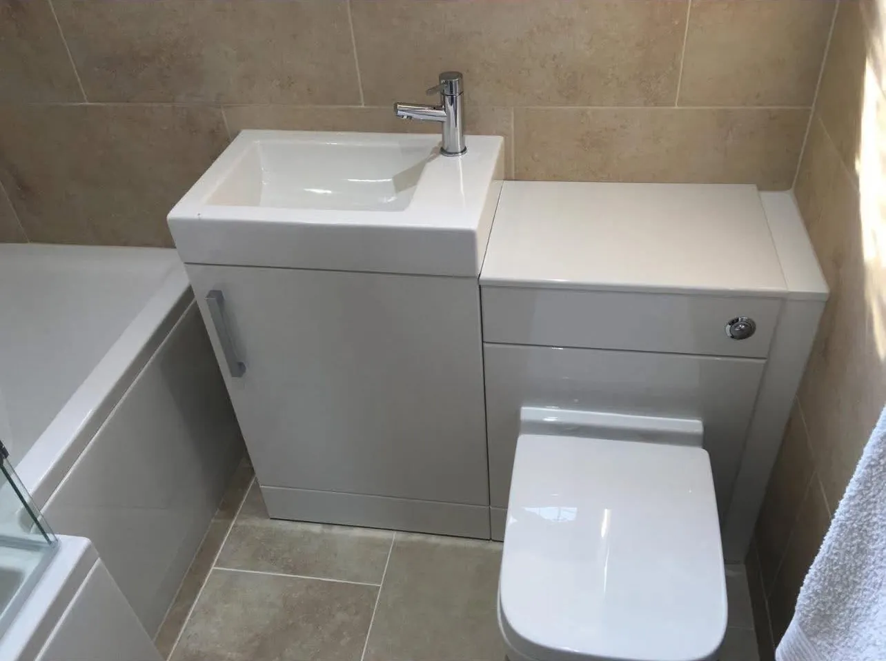 Compact combined basin and toilet unit plumbed in next to a bath
