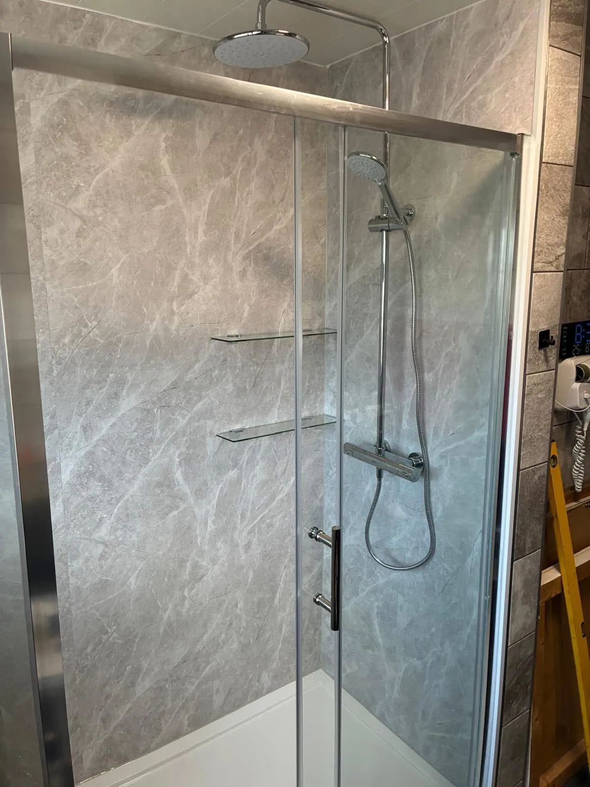Thermostatic shower with rainfall head and sliding glass enclosure installed
